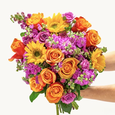 Vibrant mixed floral bouquet featuring sunflowers, roses, and colorful blossoms.