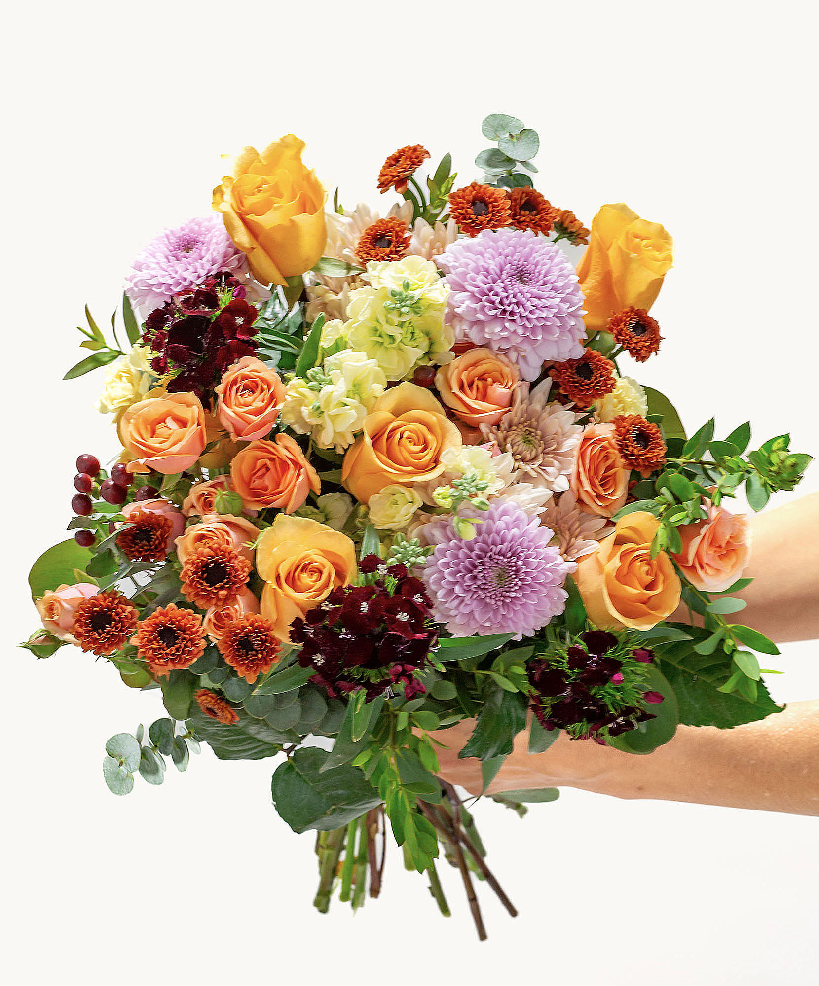 Vibrant bouquet featuring orange and purple blooms, perfect for any celebration or event.