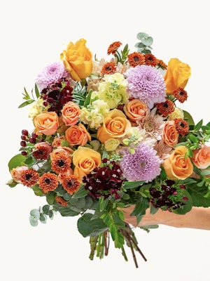 Vibrant bouquet featuring orange and purple blooms, perfect for any celebration or event.