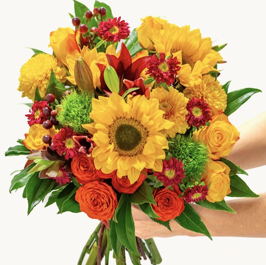 Vibrant bouquet of sunflowers, roses, and autumn blooms, perfect for cheerful occasions.