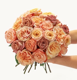 Vibrant bouquet of pastel roses in peach, pink, and cream tones, perfect for celebrations.