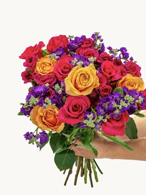 Vibrant bouquet of roses in red, orange, and purple hues, perfect for celebrations.