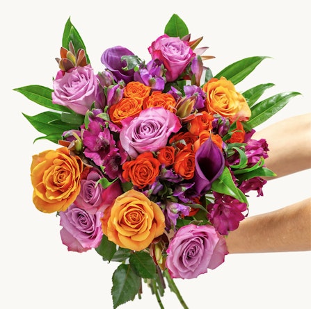 Vibrant bouquet featuring orange, pink, and purple roses, perfect for celebrations.
