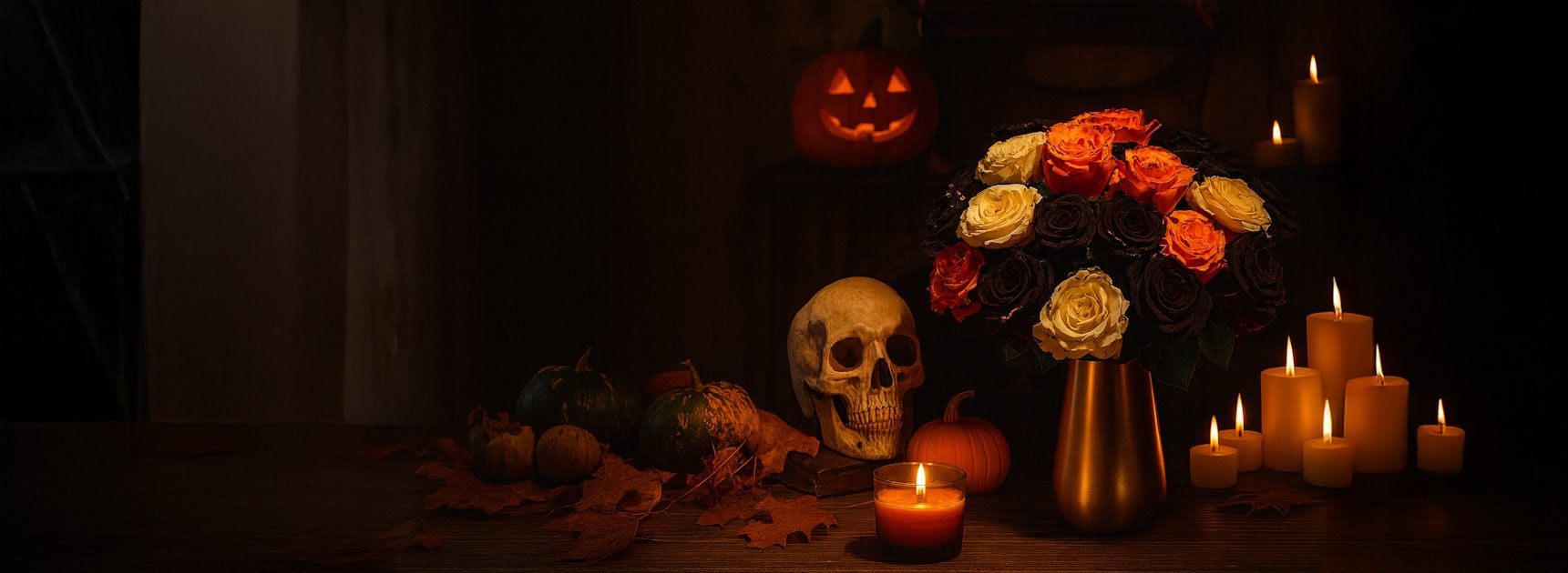 A spooky autumn scene featuring a floral arrangement with roses, skull, and pumpkins.