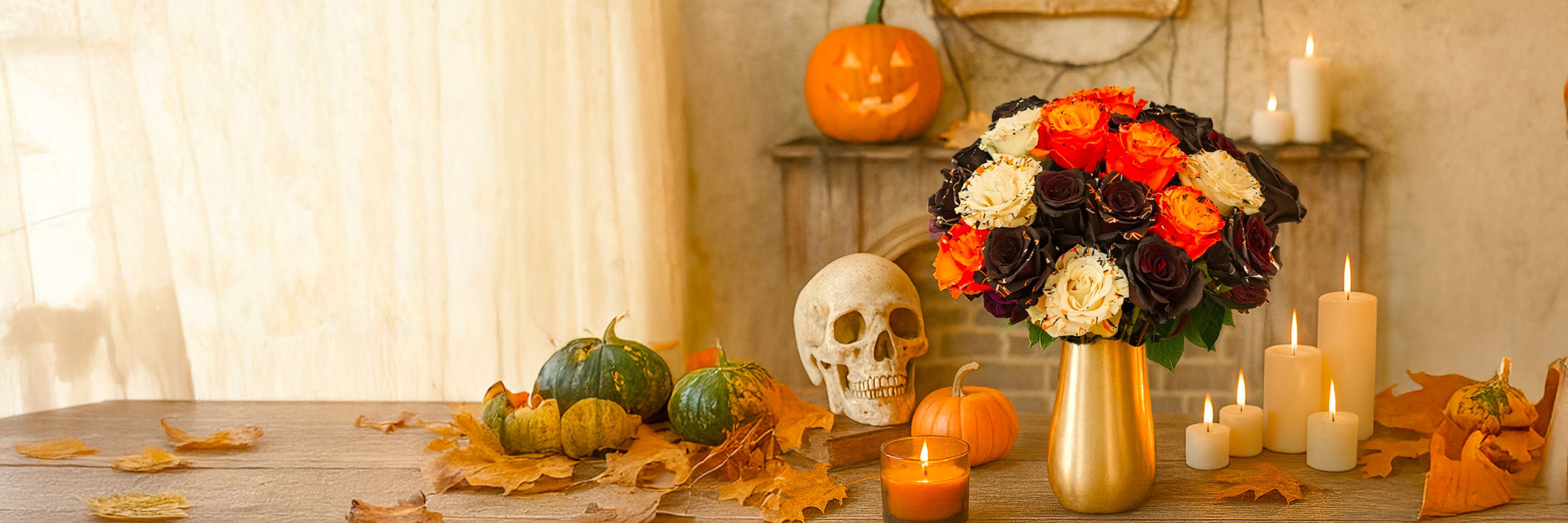 Charming autumn floral arrangement featuring orange, black, and white roses, perfect for Halloween.