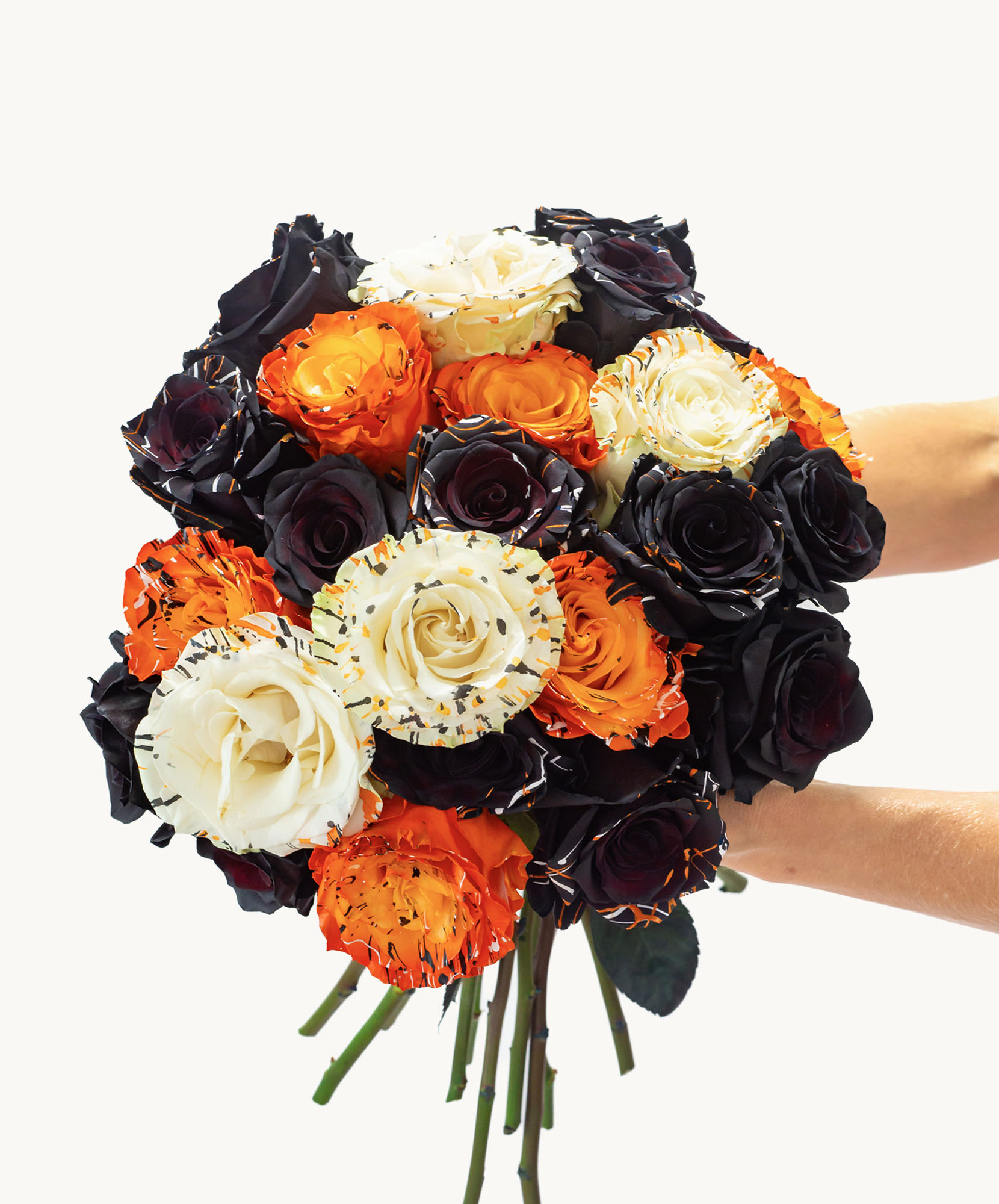 Vibrant bouquet featuring black, orange, and white roses, perfect for celebrations.