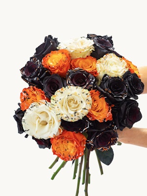 Vibrant bouquet featuring black, orange, and white roses, perfect for celebrations.
