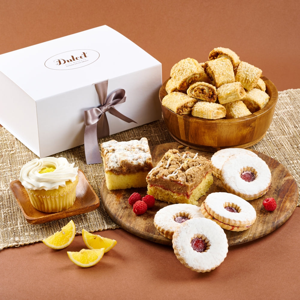Delicious assortment of baked treats including cookies, cake, and a cupcake set for sharing.