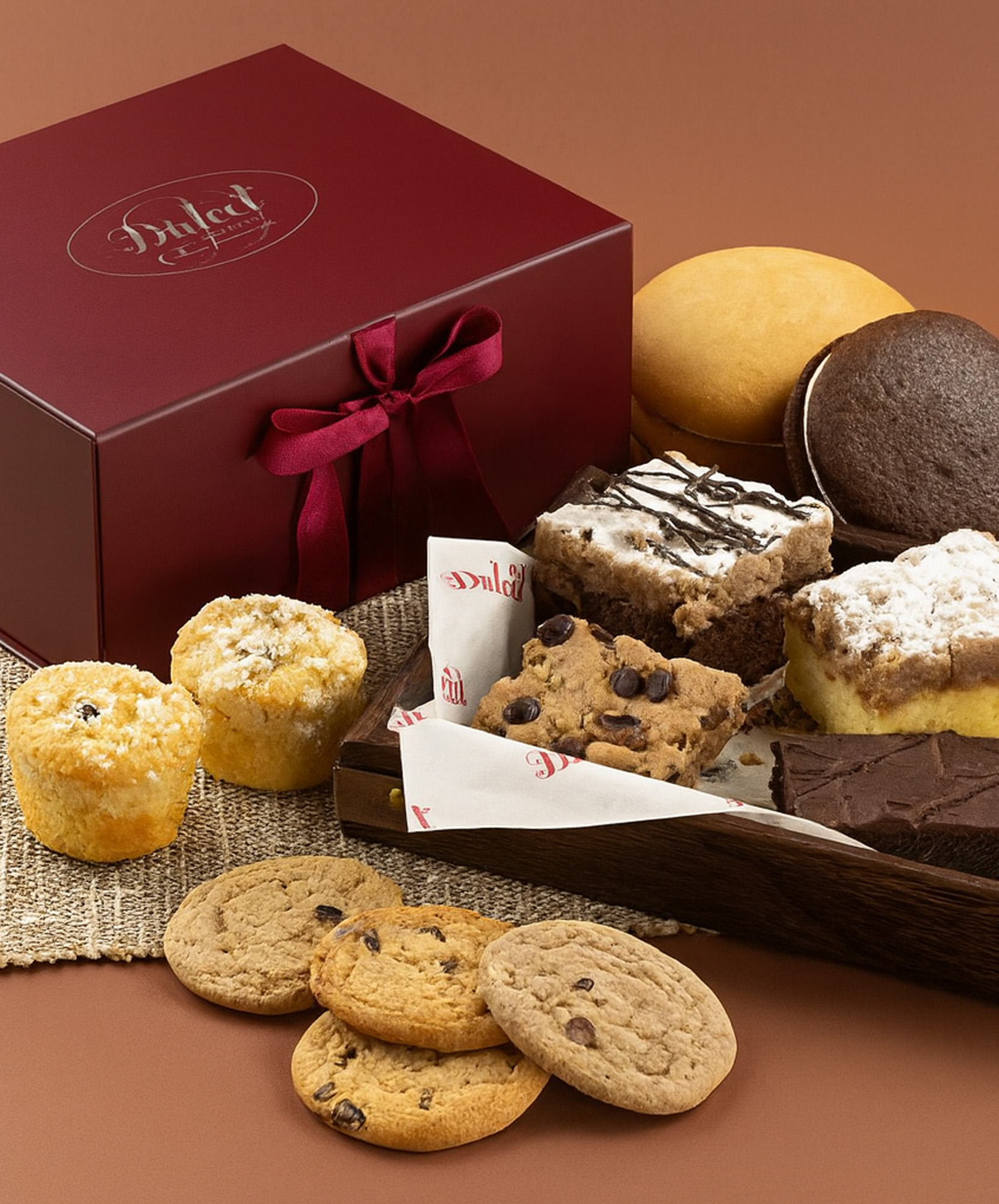 Delicious assortment of cookies and brownies presented in an elegant gift box.