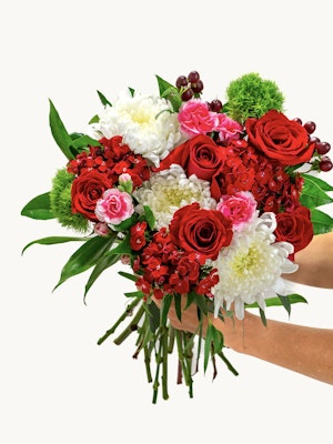 Vibrant bouquet featuring red roses, pink blooms, and white chrysanthemums, elegantly arranged.
