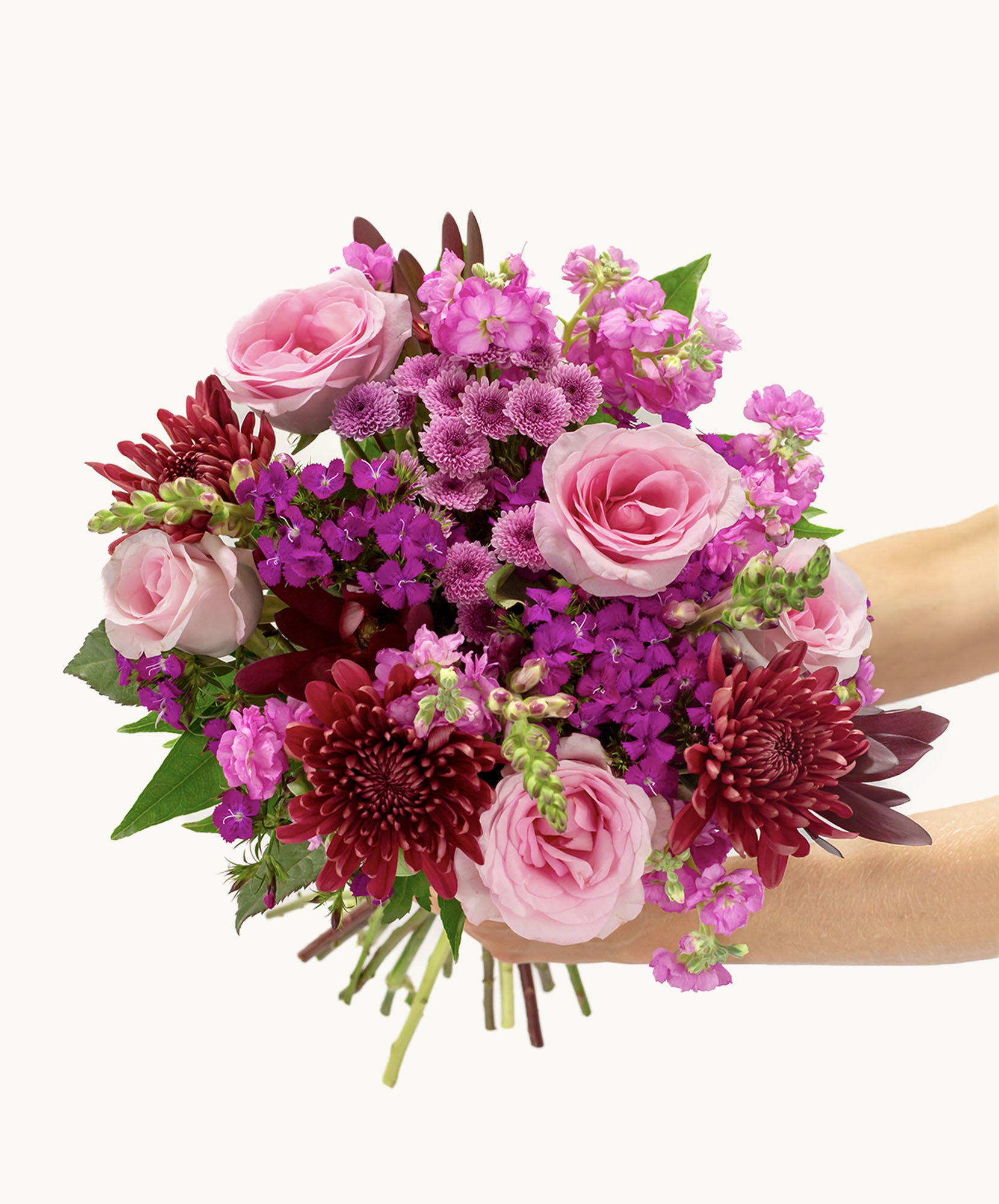 Vibrant floral bouquet featuring pink roses, purple blooms, and lush greenery, ideal for gifting.