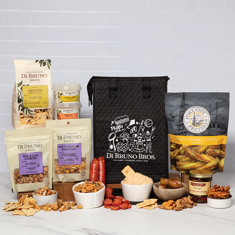 Gourmet gift basket featuring snacks, cheeses, and a savory spread for gourmet lovers.