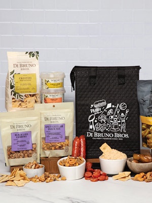 Gourmet gift basket featuring snacks, cheeses, and a savory spread for gourmet lovers.