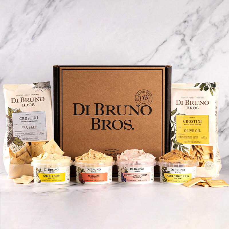 Gourmet cheese spread gift box featuring crostini and various artisanal cheeses.