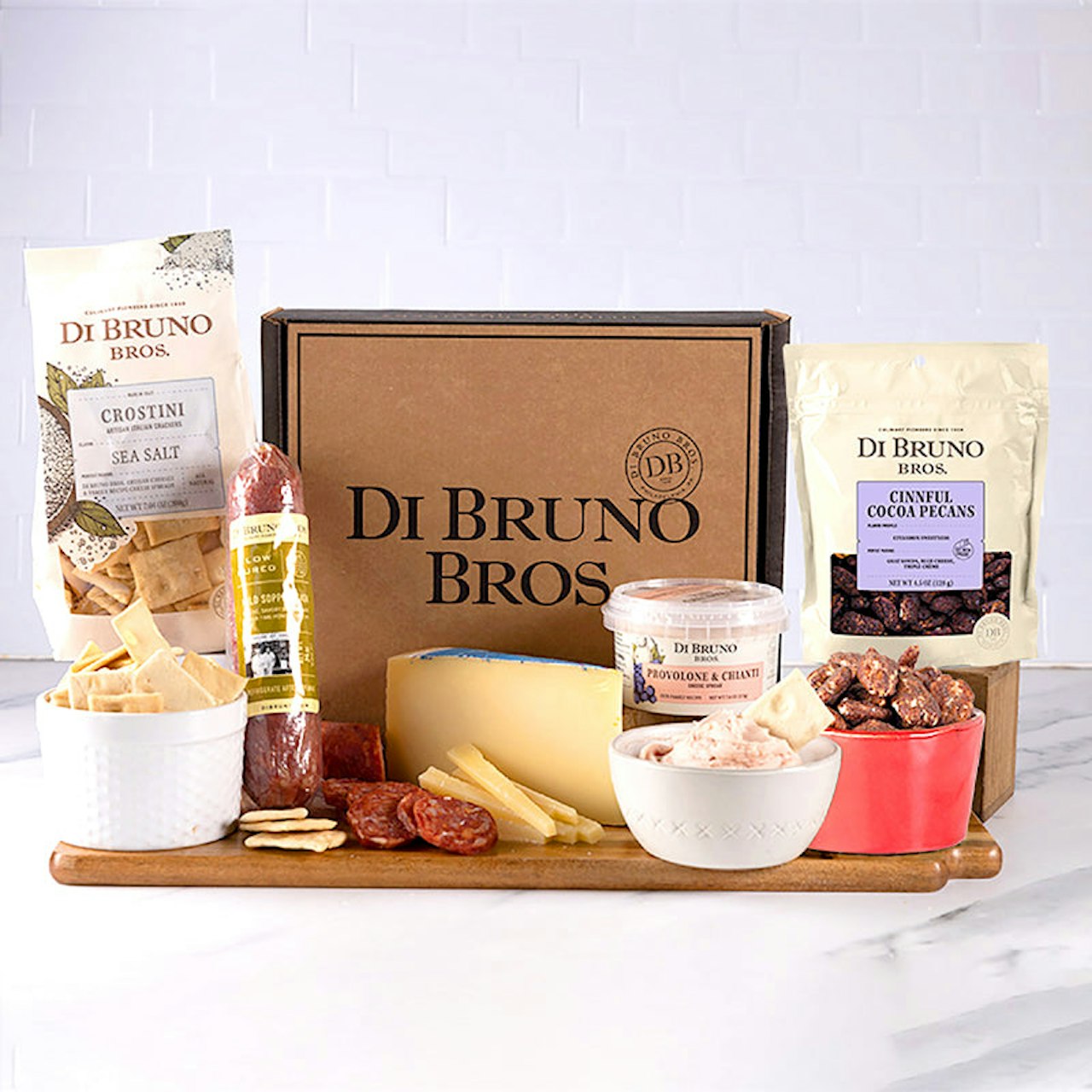 Gourmet cheese and charcuterie gift box featuring high-quality snacks and treats.