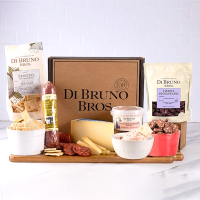 Gourmet cheese and charcuterie gift box featuring high-quality snacks and treats.