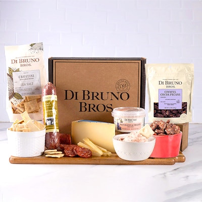 Gourmet cheese and charcuterie gift box featuring high-quality snacks and treats.