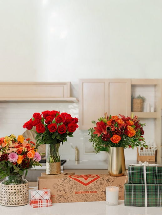 Vibrant floral arrangements in vases, showcasing red roses and colorful blossoms on display.