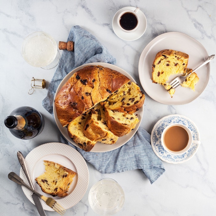 Deliciously sliced sweet bread with chocolate, served on elegant plates and coffee.