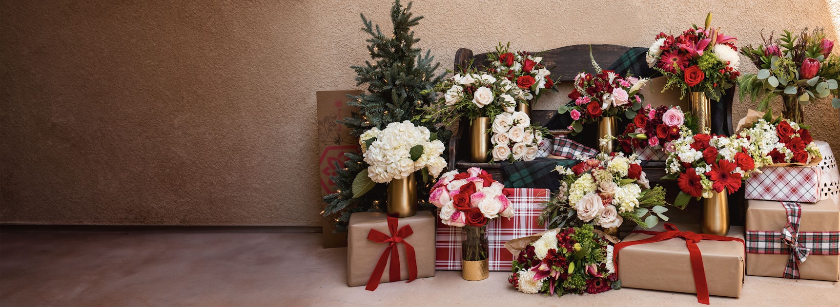Festive floral arrangements beside beautifully wrapped gifts for special occasions.