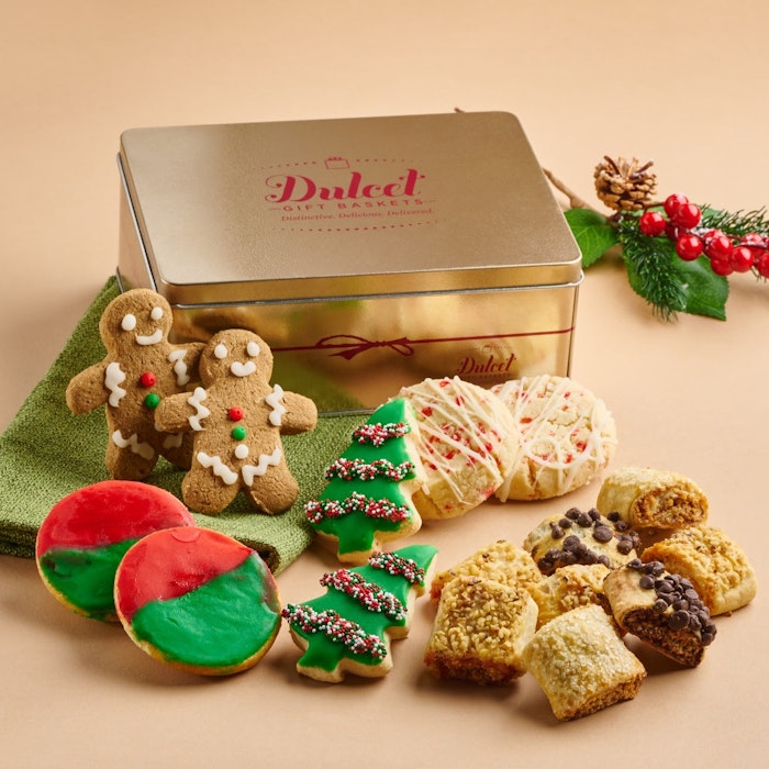 A festive assortment of holiday cookies and treats arranged in a decorative gift tin.