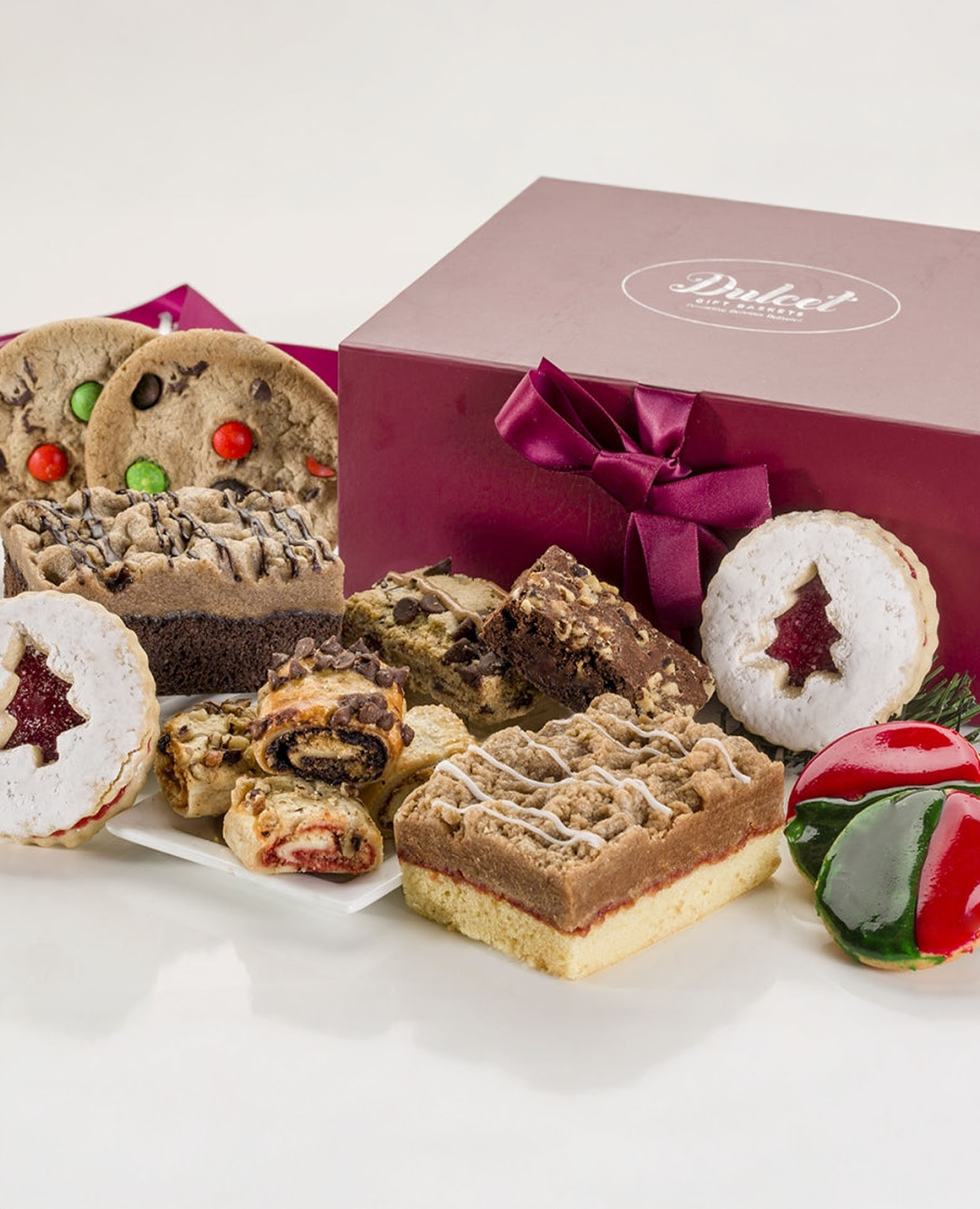 Assorted festive cookies and treats beautifully arranged in a gift box, perfect for celebrations.