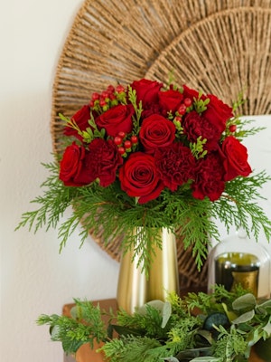 Vibrant red rose bouquet featuring greenery, perfect for festive celebrations and gifts.