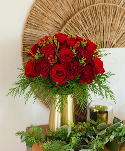 Vibrant red rose bouquet featuring greenery, perfect for festive celebrations and gifts.
