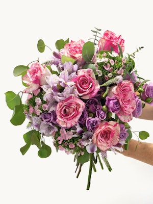 Vibrant bouquet featuring pink roses, purple alstroemeria, and lush greenery.