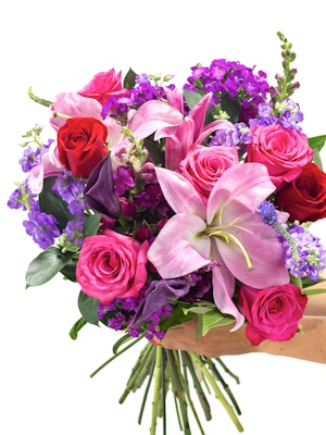Vibrant floral bouquet featuring pink lilies, red roses, and purple blooms, perfect for celebrations.