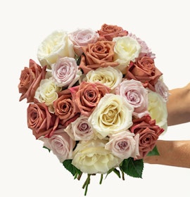 Beautiful bouquet of mixed roses in soft peach and creamy white hues, elegantly arranged for gifting.