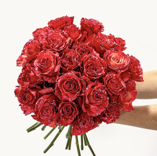 Vibrant bouquet of striking red roses held in hands, perfect for celebrations and love.