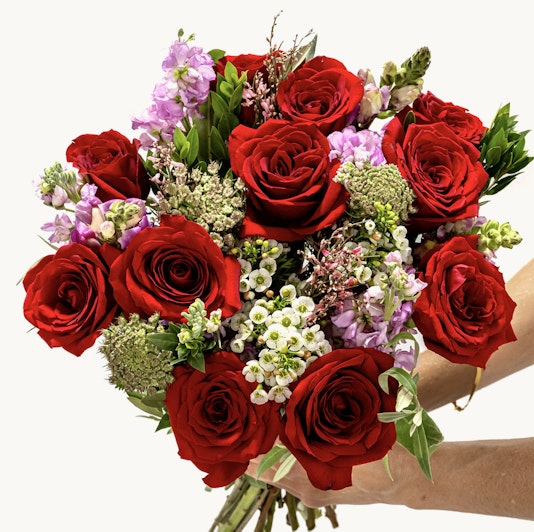 Vibrant bouquet featuring lush red roses and delicate purple flowers, perfect for any occasion.