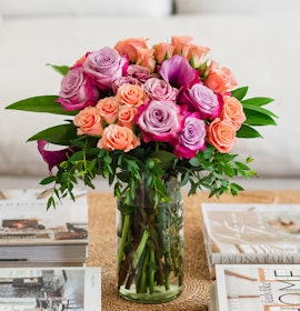 Vibrant bouquet featuring pink and purple roses in a stylish glass vase, perfect for any occasion.