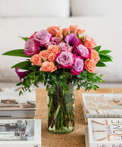 Vibrant bouquet featuring pink and purple roses in a stylish glass vase, perfect for any occasion.