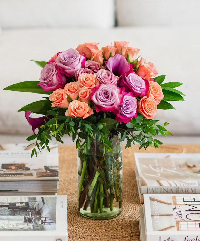 Vibrant bouquet featuring pink and purple roses in a stylish glass vase, perfect for any occasion.