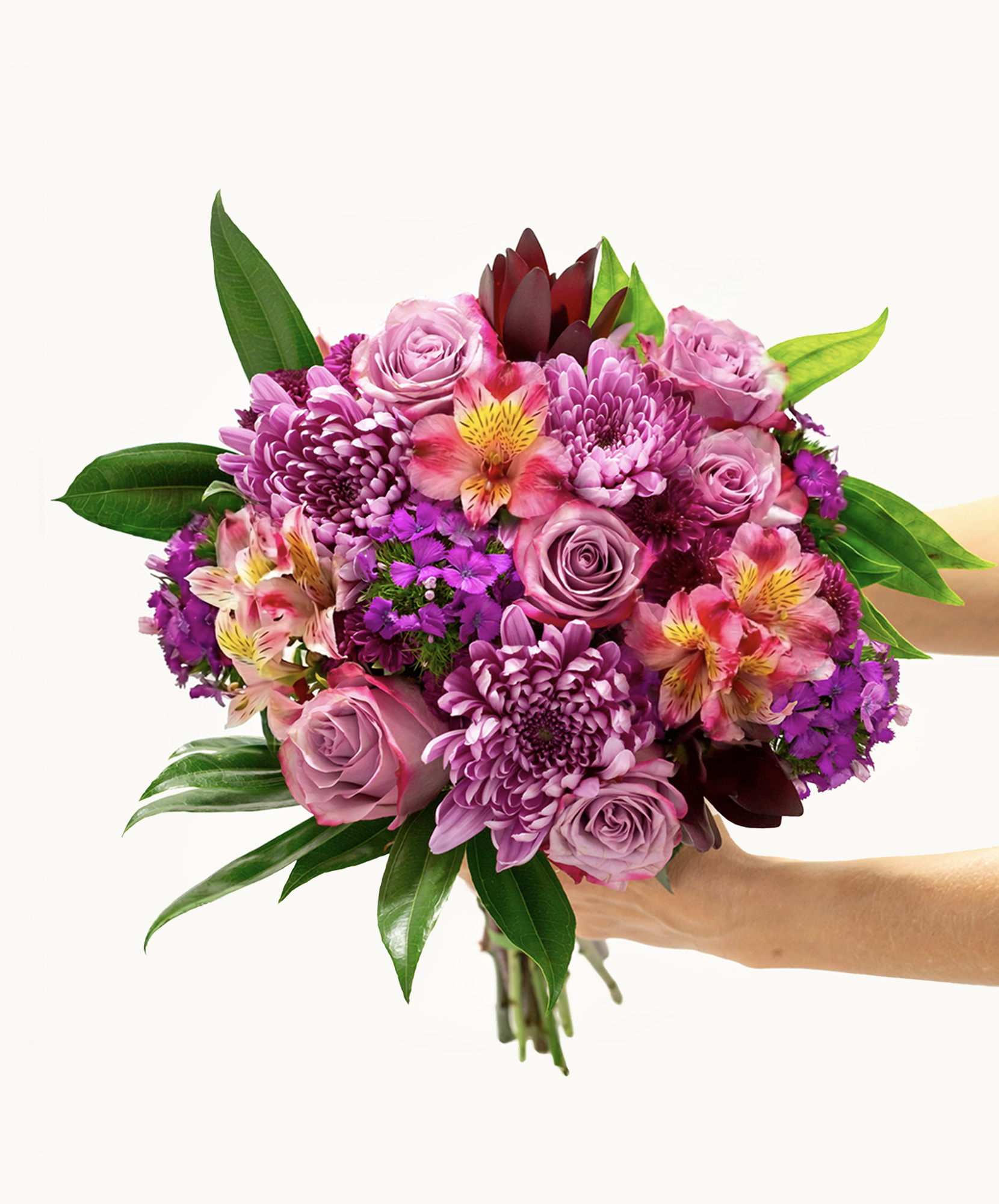 Vibrant bouquet featuring pink roses, chrysanthemums, and lush greenery, ideal for celebrations.