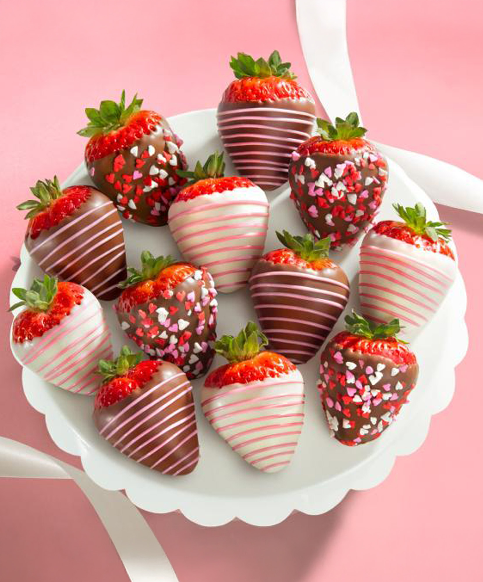 A delightful platter of chocolate-covered strawberries decorated with festive sprinkles.
