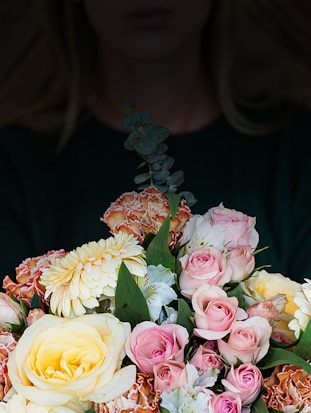 Vibrant floral bouquet featuring yellow roses, pink blooms, and greenery for special occasions.