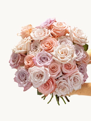 A stunning bouquet of pastel roses in soft pink and lavender hues, perfect for gifting.