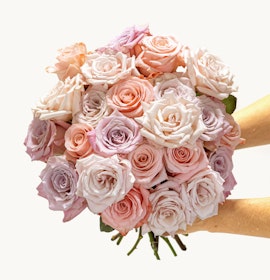 A stunning bouquet of pastel roses in soft pink and lavender hues, perfect for gifting.