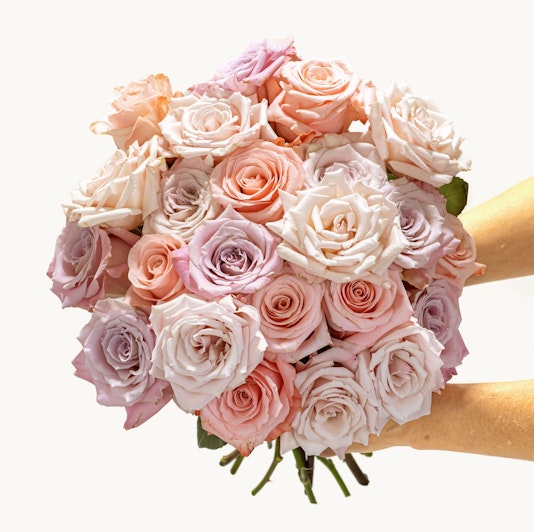 A stunning bouquet of pastel roses in soft pink and lavender hues, perfect for gifting.