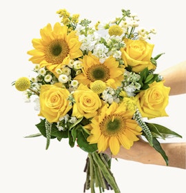 Bright and cheerful bouquet featuring sunflowers, yellow roses, and white accents.
