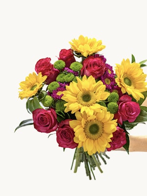 Vibrant bouquet featuring sunflowers, pink roses, and green chrysanthemums, ideal for celebrations.