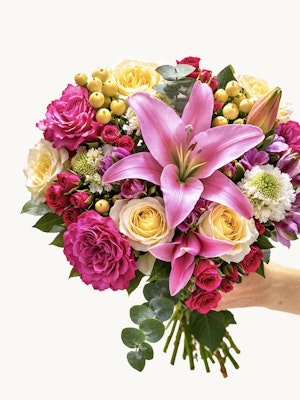 Vibrant flower bouquet featuring pink lilies, yellow roses, and colorful blooms.