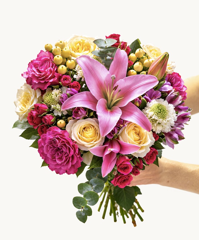 Vibrant flower bouquet featuring pink lilies, yellow roses, and colorful blooms.