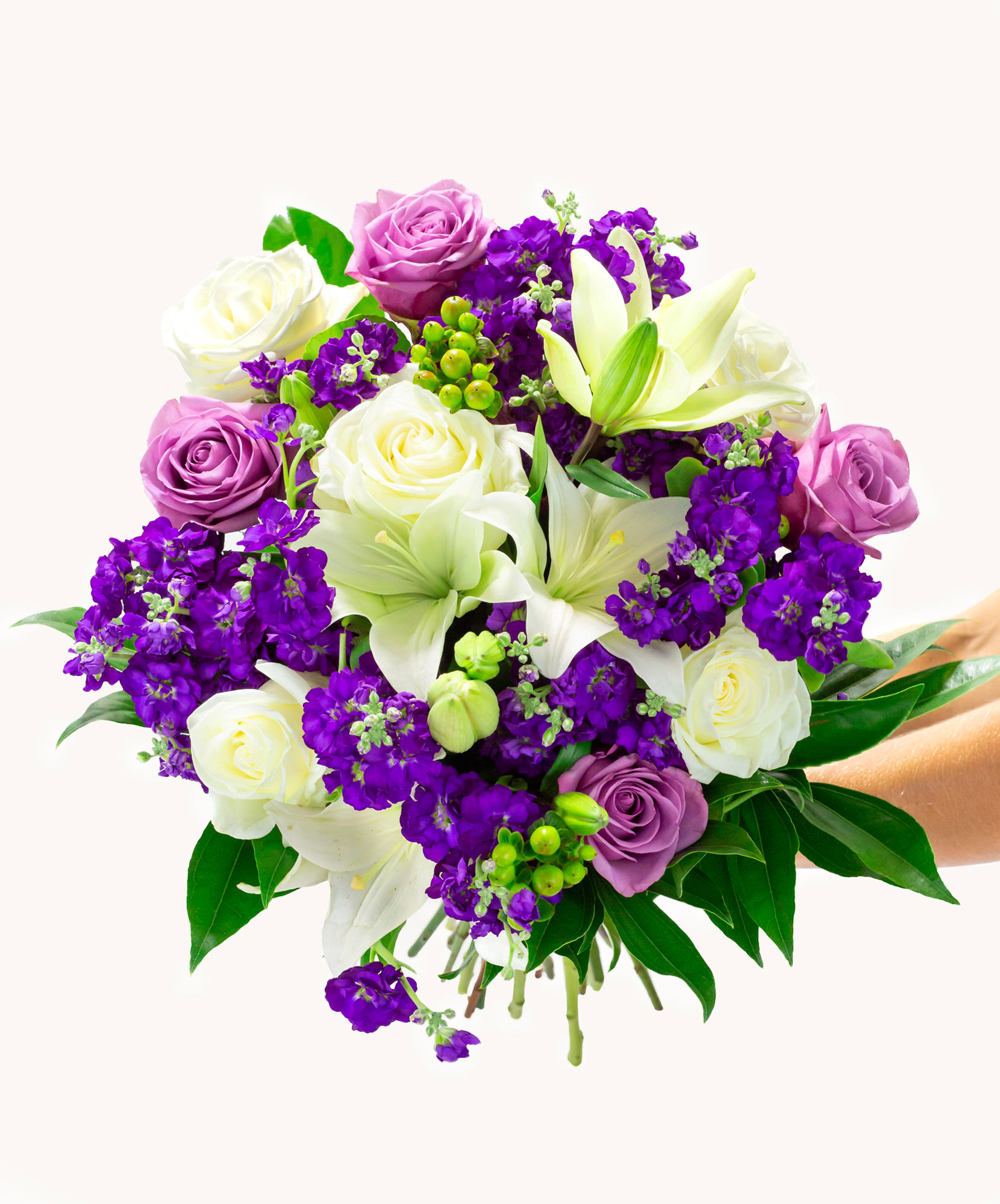Vibrant floral bouquet featuring white lilies, purple and lavender roses, and lush greenery.