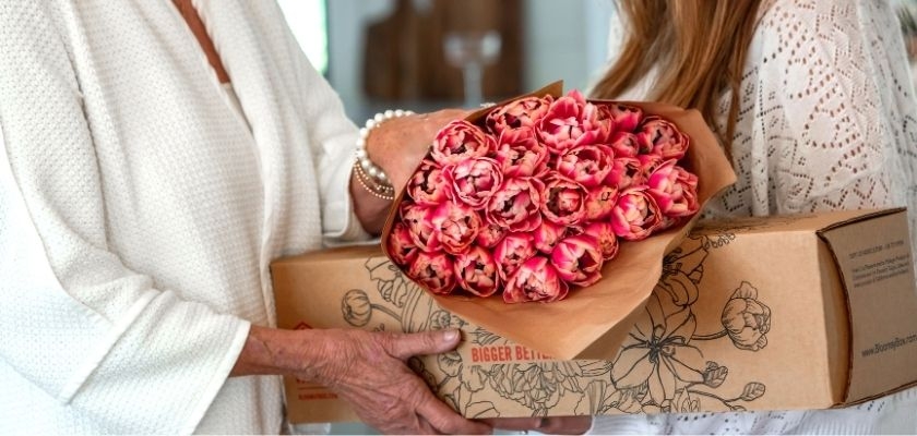 A beautiful bouquet of pink tulips thoughtfully presented in a charming floral box.