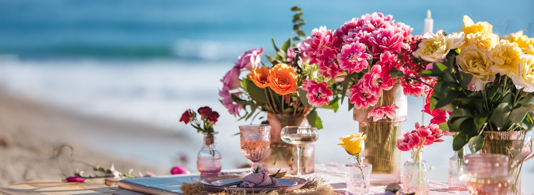 Vibrant beachside floral arrangement with colorful blooms and elegant decor.