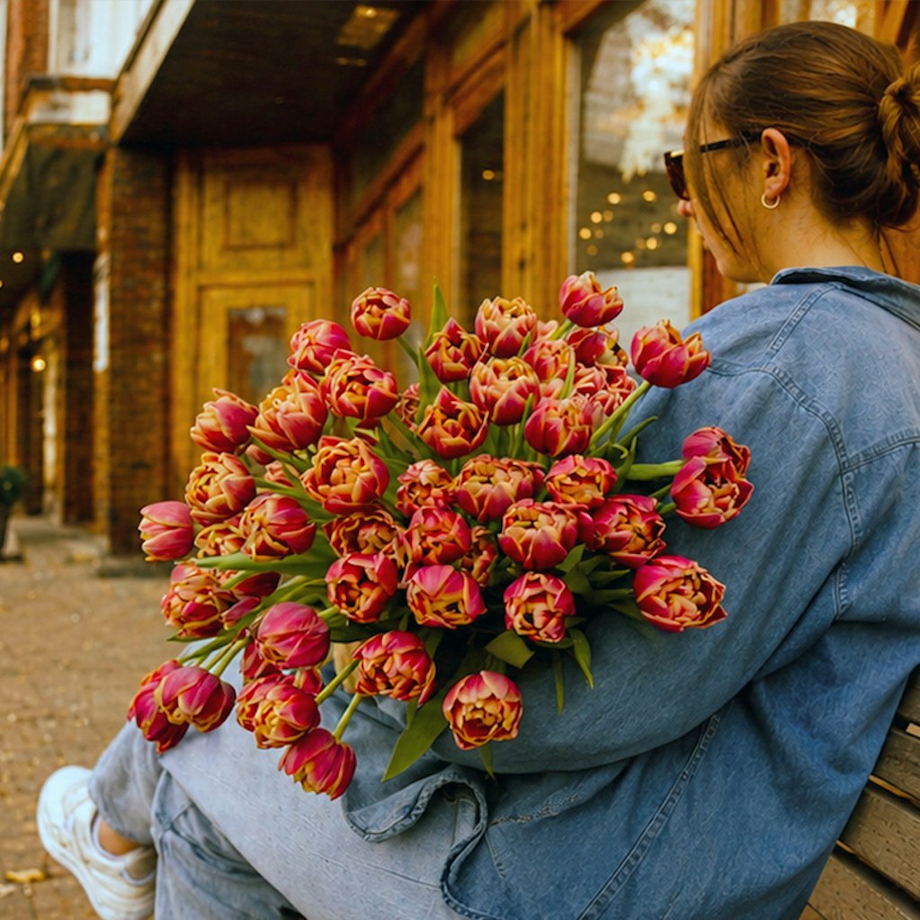 A vibrant bouquet of double tulips in shades of pink, perfect for spring celebrations.